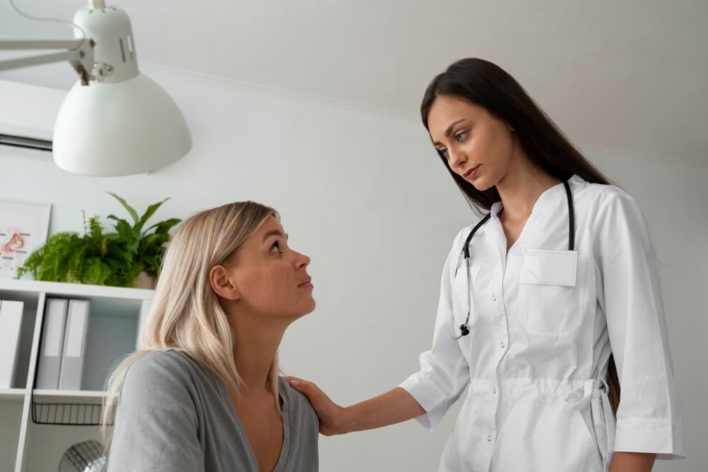 A doctor providing comfort to a concerned patient in a clinic